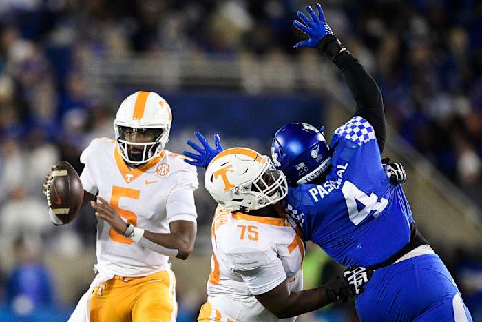 Tennessee quarterback Hendon Hooker (5) looks to pass as Tennessee offensive lineman Jerome Carvin (75) defends against Kentucky defensive end Josh Paschal (4) during an SEC football game between Tennessee and Kentucky at Kroger Field in Lexington, Ky. on Saturday, Nov. 6, 2021. Kns Tennessee Kentucky Football